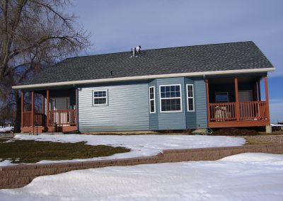 Side view of blue house with two patios
