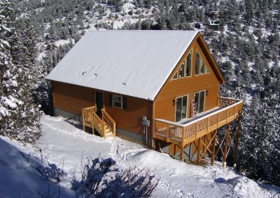 Home with large deck on side of mountain
